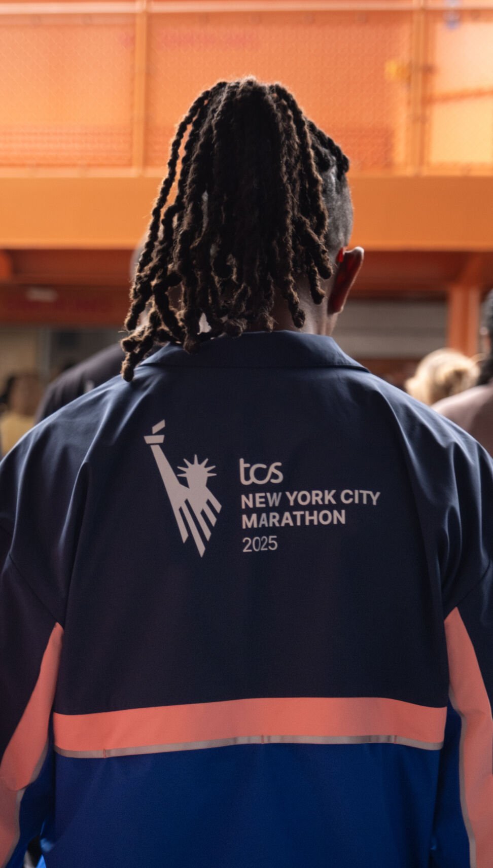 Two men wearing New York City Marathon apparel 